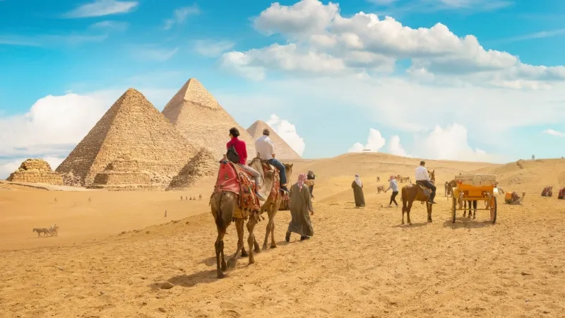Camel Riding Around Pyramids